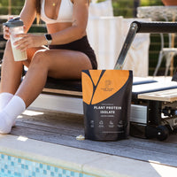 Salted Caramel Plant Protein Powder in front of a pool on a reformer pilate 